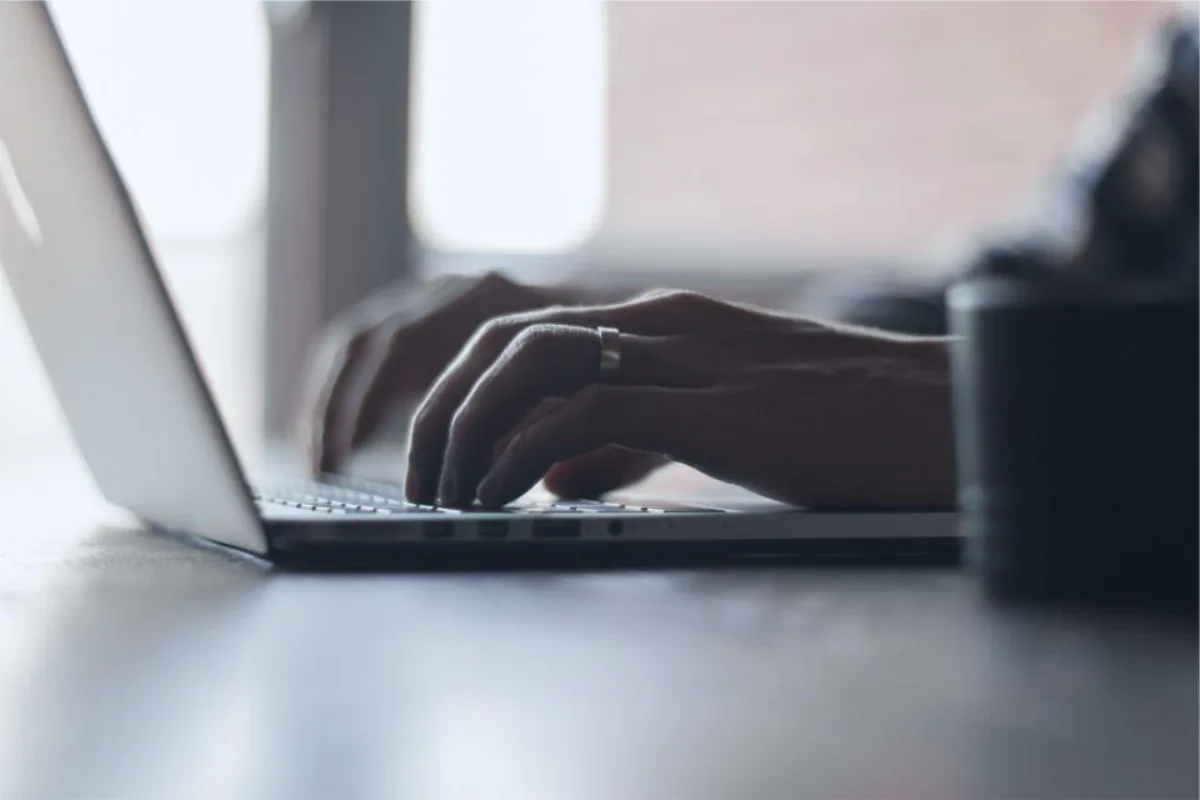 Hands at a laptop keyboard during a working session